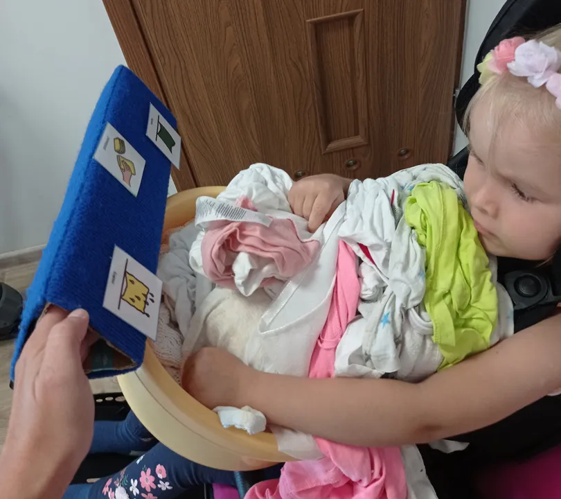 poznawanie nowych znaków w kontekście naturalnej sytuacji - na tablicy mokry i suchy z rzeczami zdjętymi z suszarki