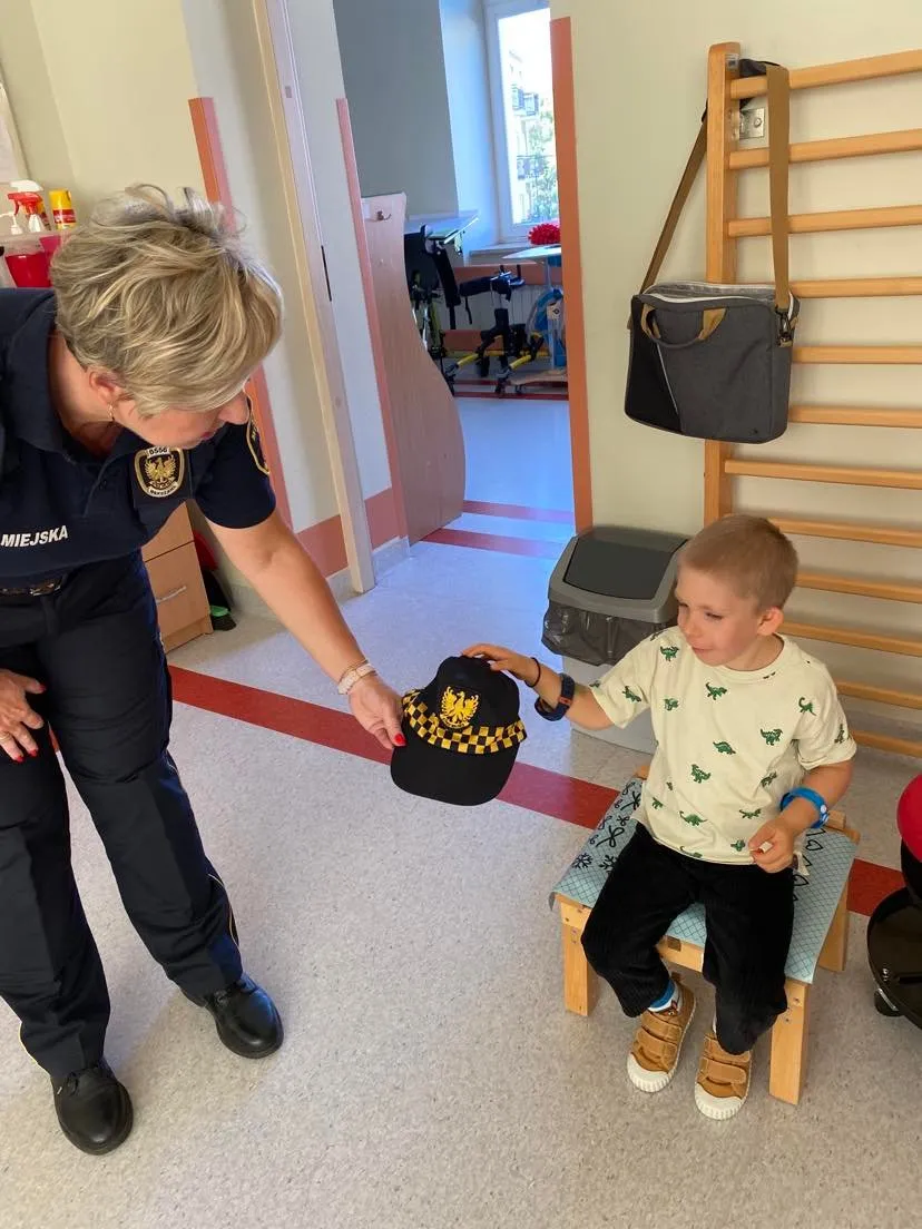 Tymon ogląda czapkę Pani ze Straży Miejskiej